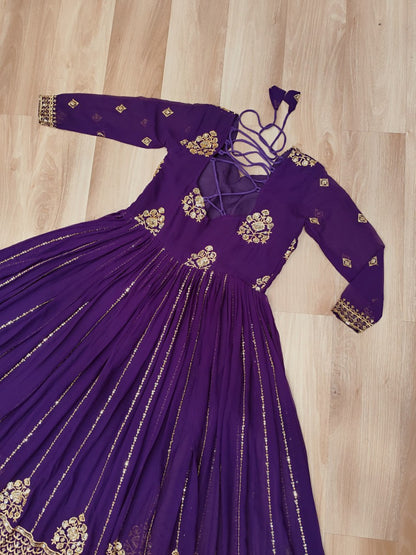 Back view of the purple designer gown with zari embroidery and tie details.