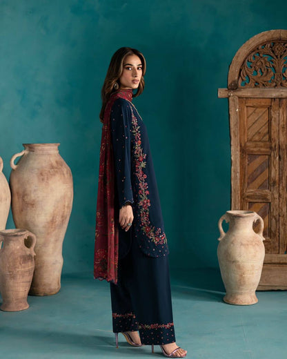 Side profile of navy blue Farsi suit with vibrant embroidery and deep maroon floral dupatta.