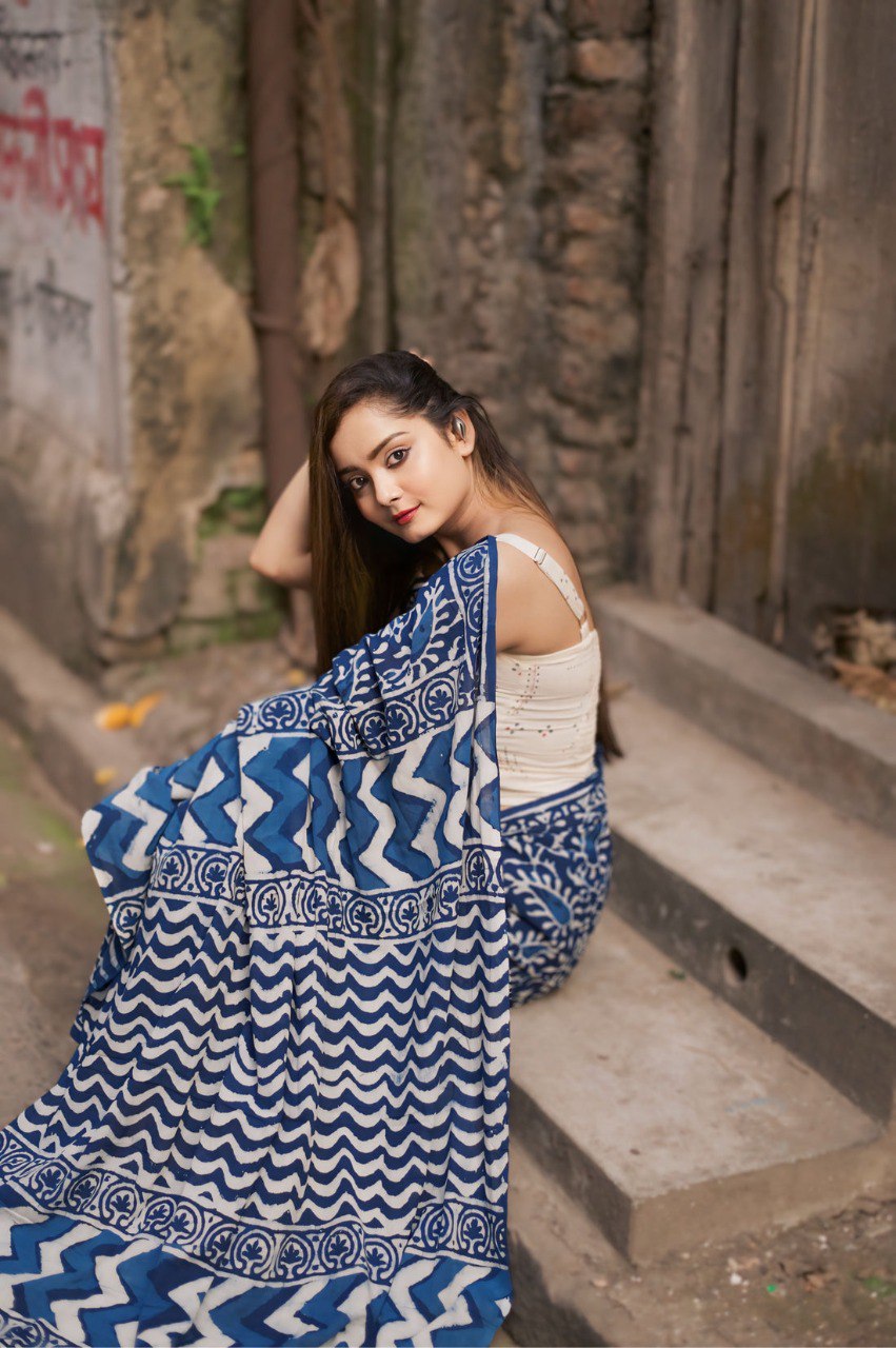 Model in a blue printed Ready to Wear Cotton Saree sitting on steps.