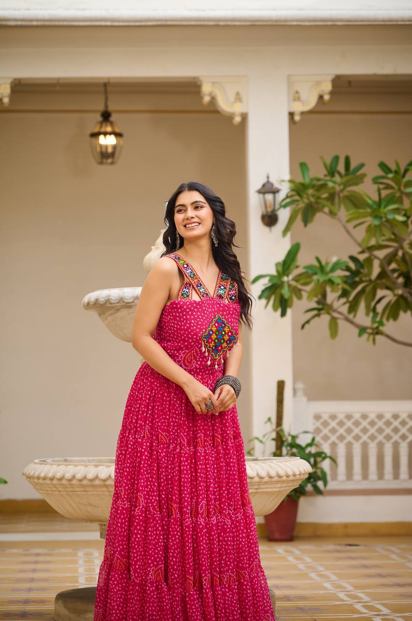 Radiant pink Bandhani gown with colorful Gamathi embroidery, perfect for festive events.