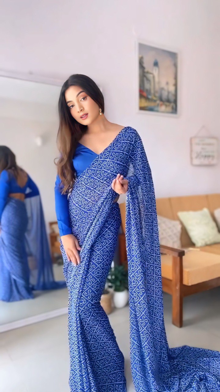 Woman wearing stylish blue georgette saree; easy to wear, fits sizes 26 to 44.