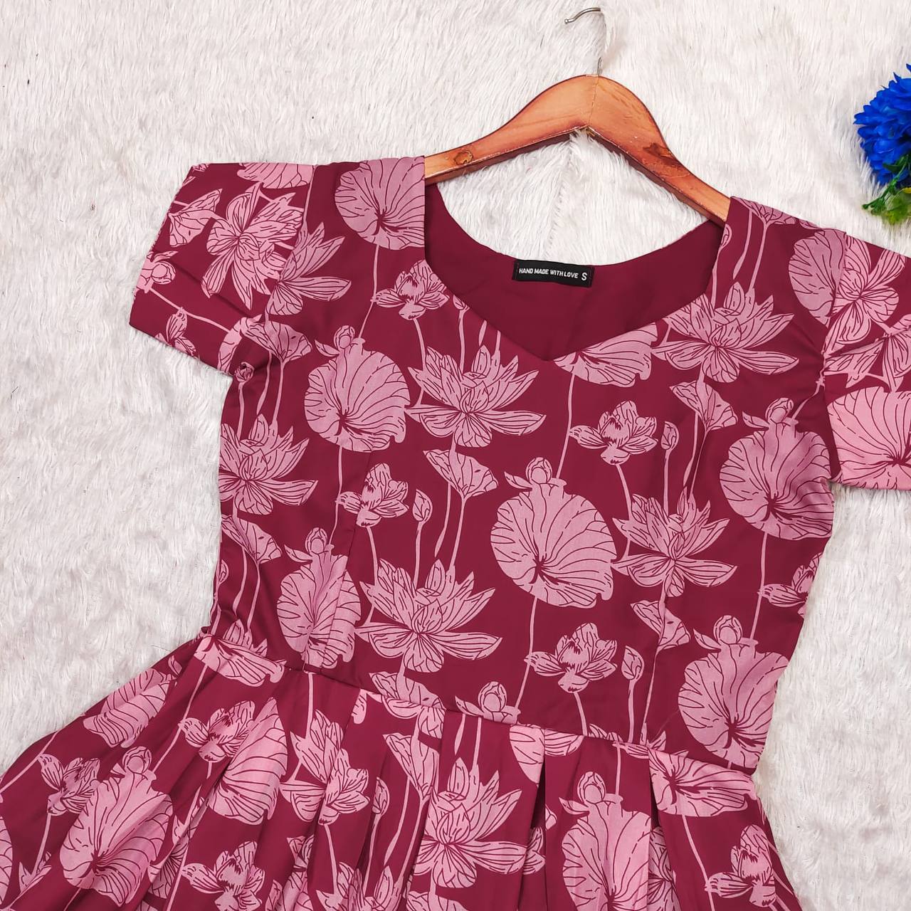 Maroon Lotus dress, close-up of the lotus floral pattern and neckline. Beautifully crafted dress.