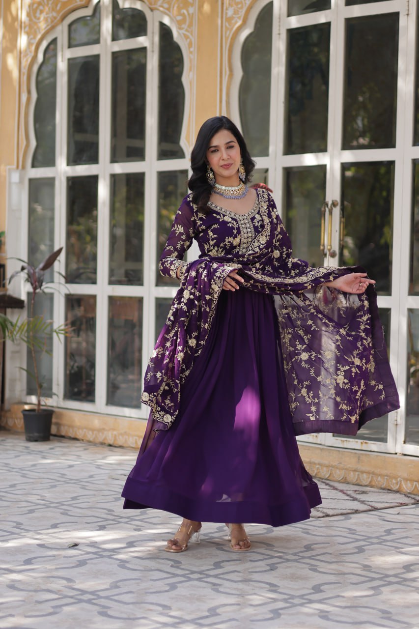 Full view of the purple embroidered gown with dupatta draped over shoulders.