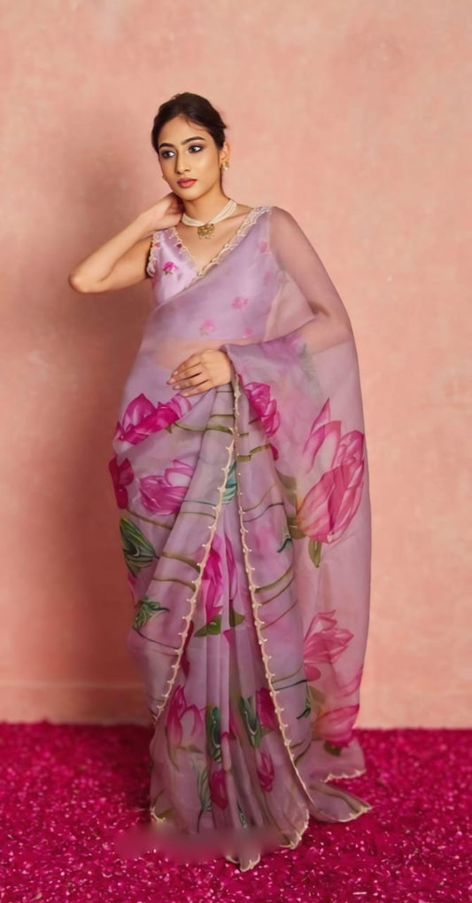 Model wearing ready to wear lilac organza saree with floral print and sleeveless blouse.