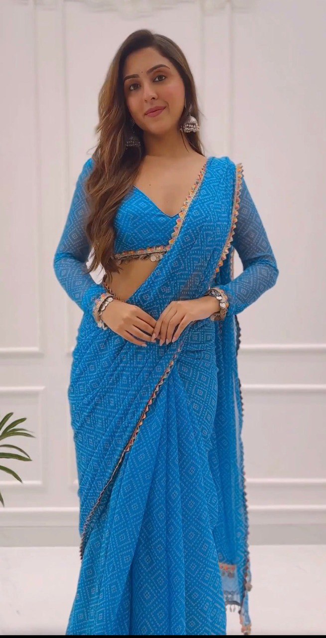 Smiling woman wearing a stylish blue ready to wear saree with matching bangles.