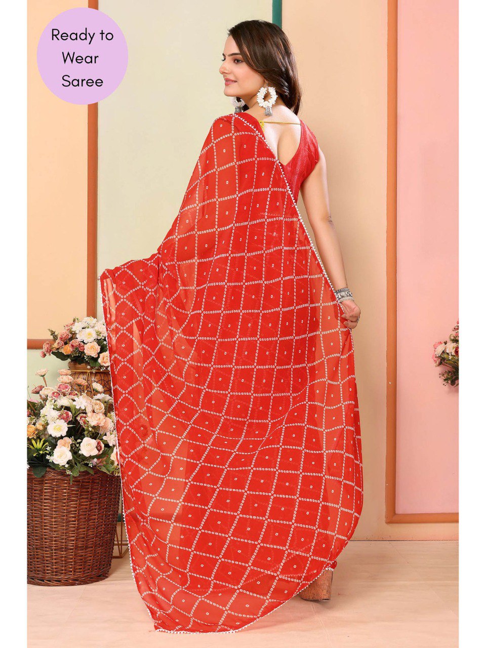 Red ready-to-wear saree with geometric pattern and white lace trim.