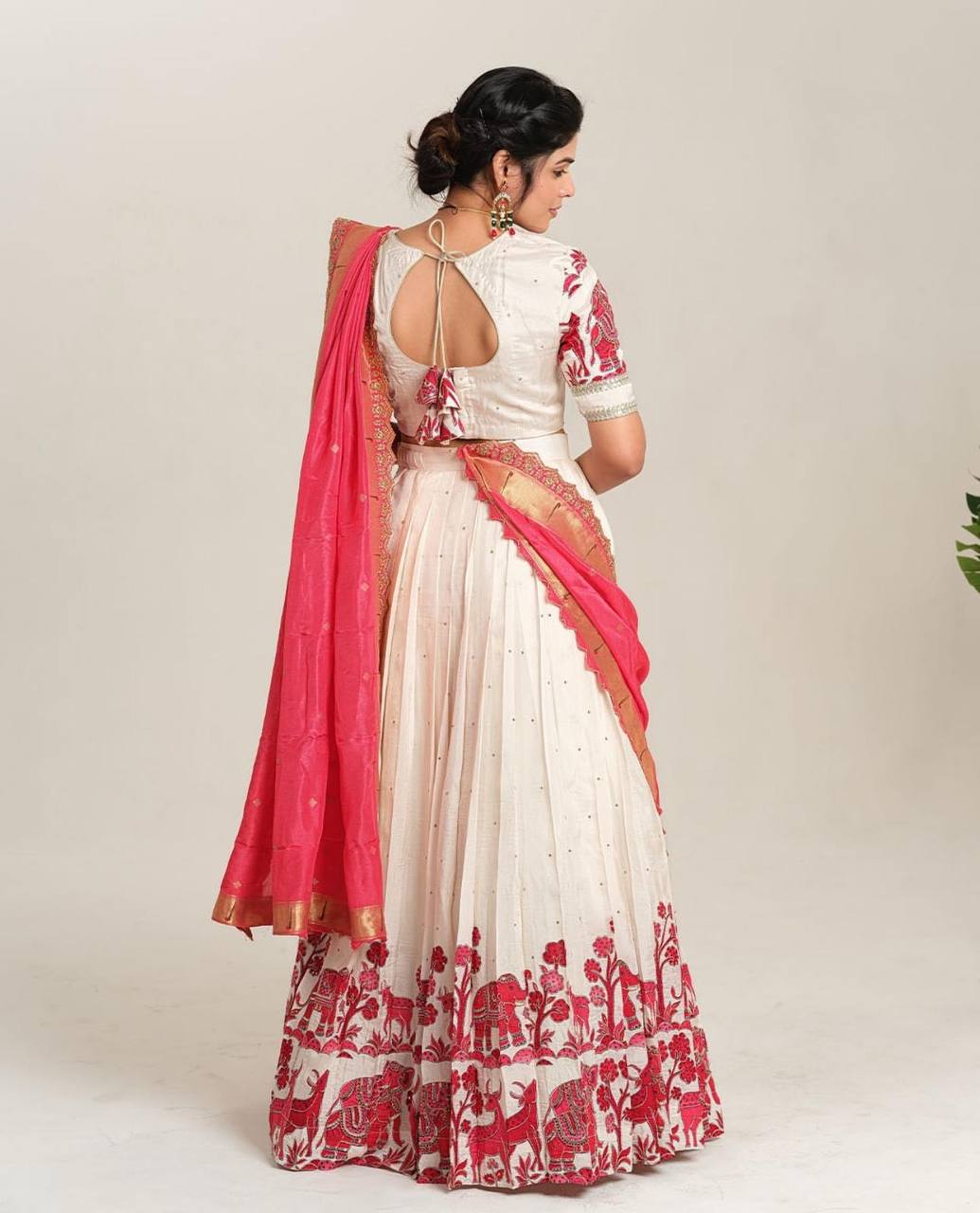 Back view of model wearing Kalamkari lehenga choli with pink dupatta.