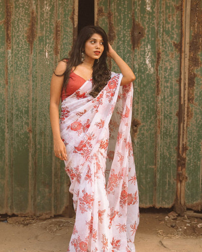 Woman wearing a ready-to-wear off white floral saree in georgette.