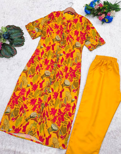 Yellow Forest Kurti and pants set with all-over red floral print, displayed flat on white background.