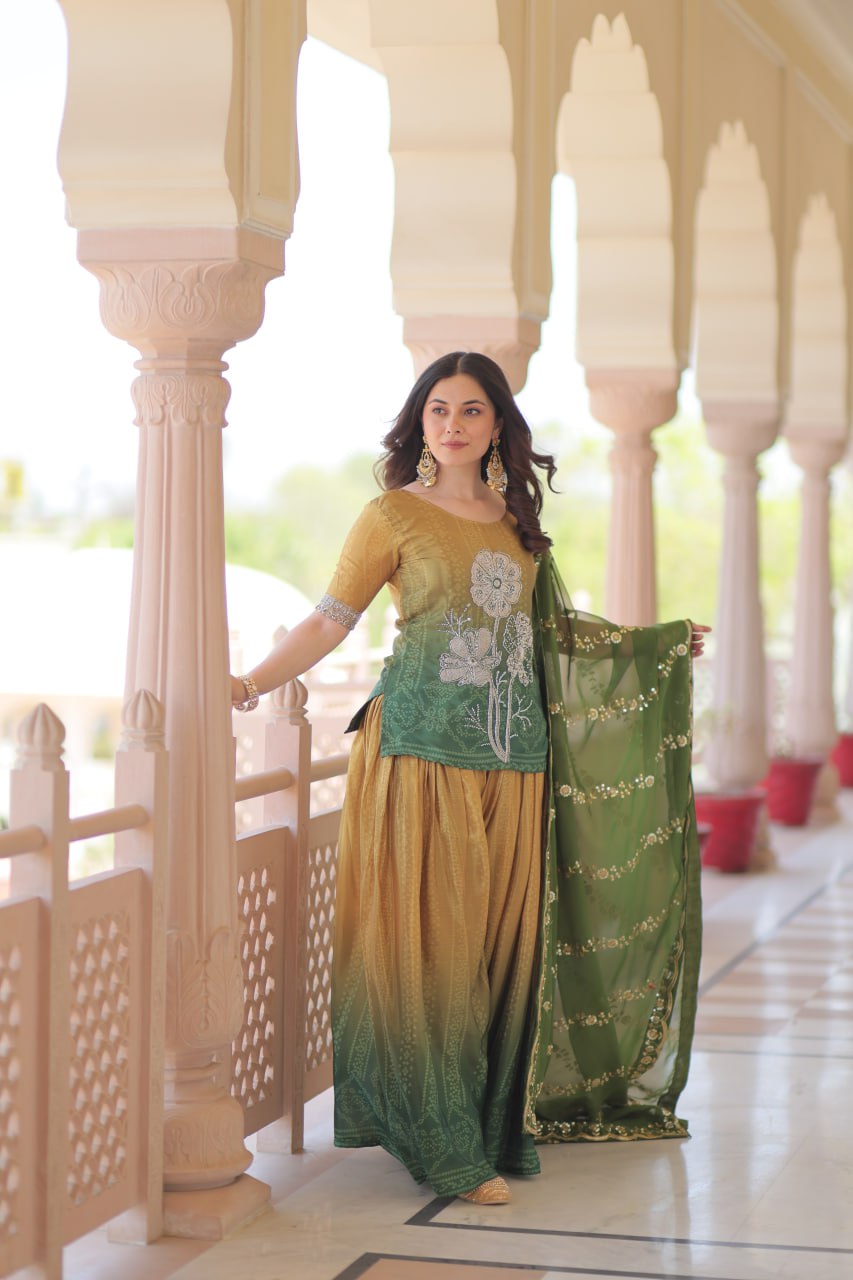 Model posing in olive green Sharara Suit with columns