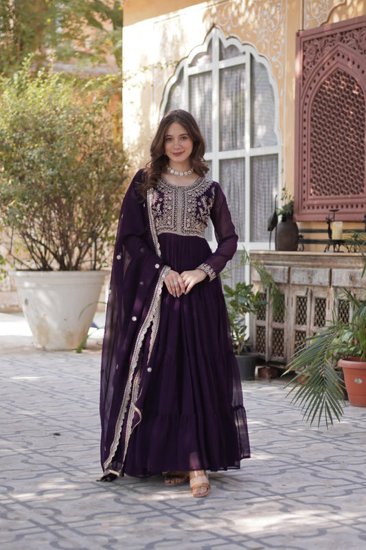 Woman in elegant purple embroidered Georgette gown with dupatta.