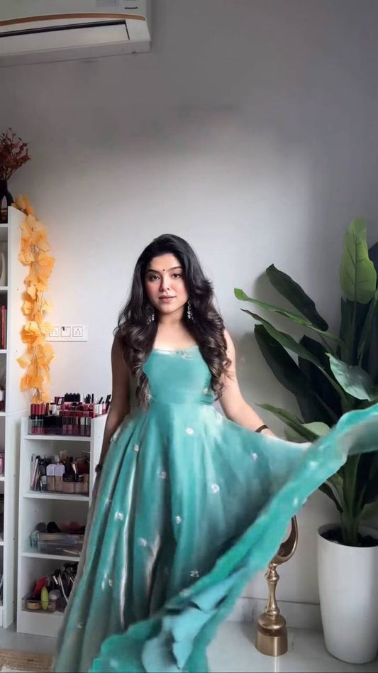 Teal designer gown ensemble flowing, perfect for party wear.