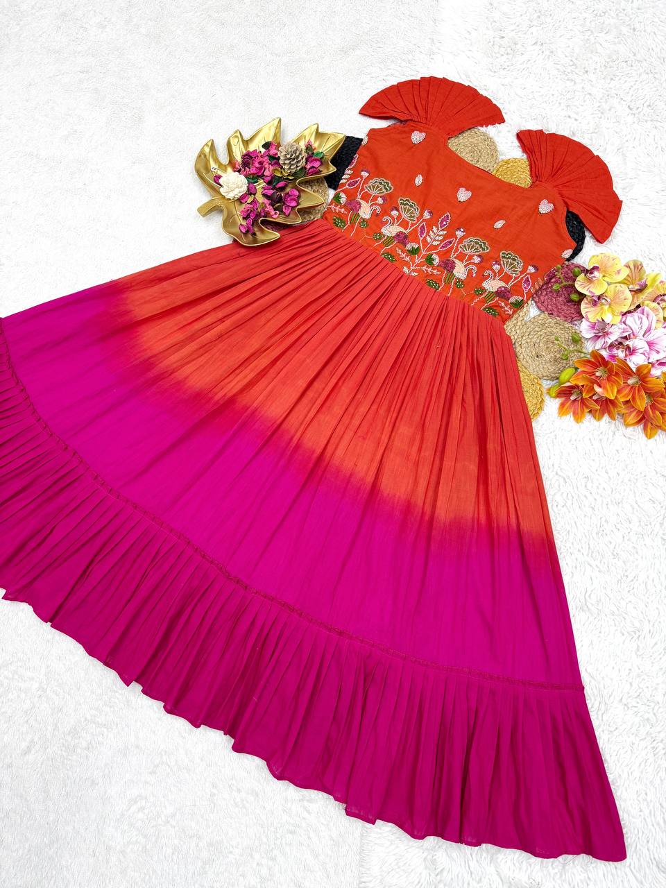 Overhead view of the orange and pink cotton gown displaying the full flair and design details.