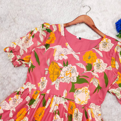 Close-up of the pink floral maxi dress on a hanger, showcasing the floral print.