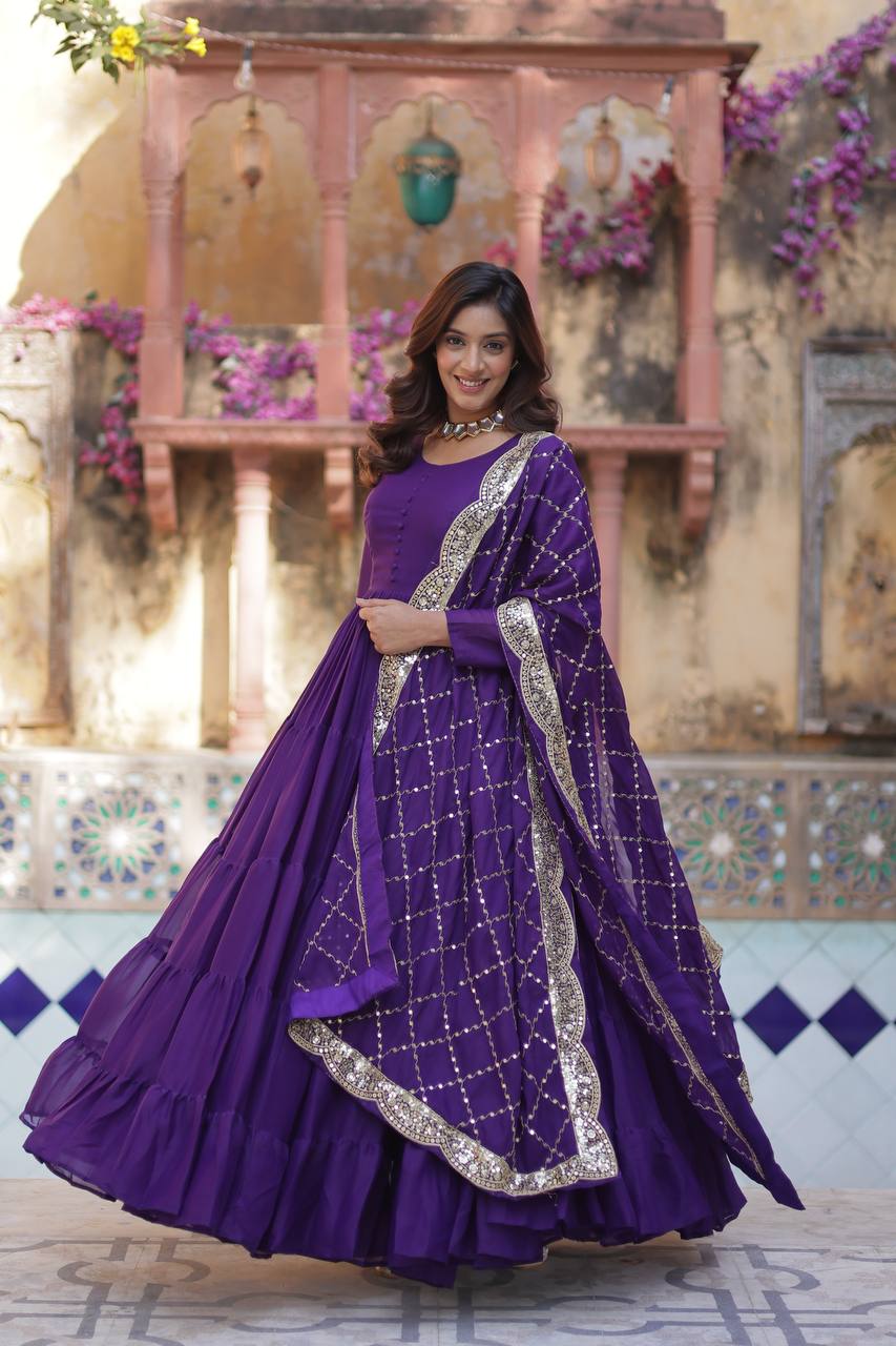 Woman in a purple flared gown with a sequin embroidered dupatta, full flair on display.