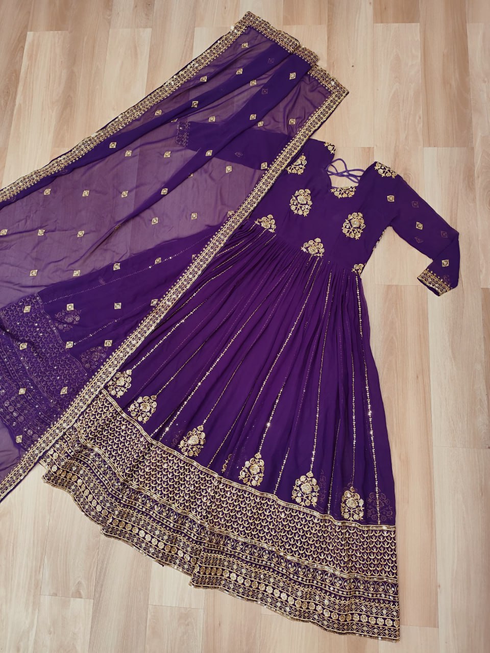 Purple Indian gown with matching dupatta featuring elegant zari and sequin work.