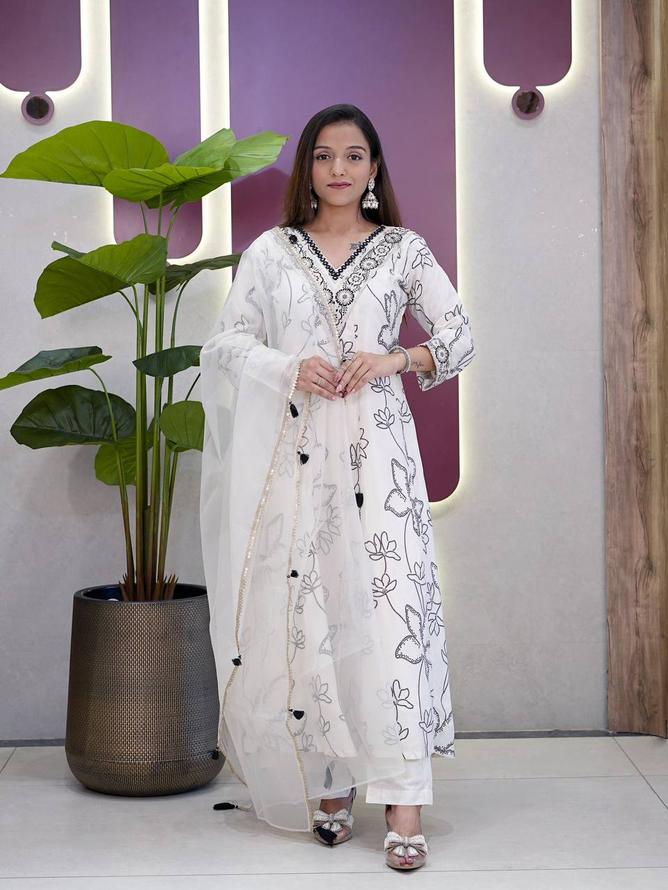 Woman wearing a stylish white Anarkali Salwar Suit with floral digital print design.