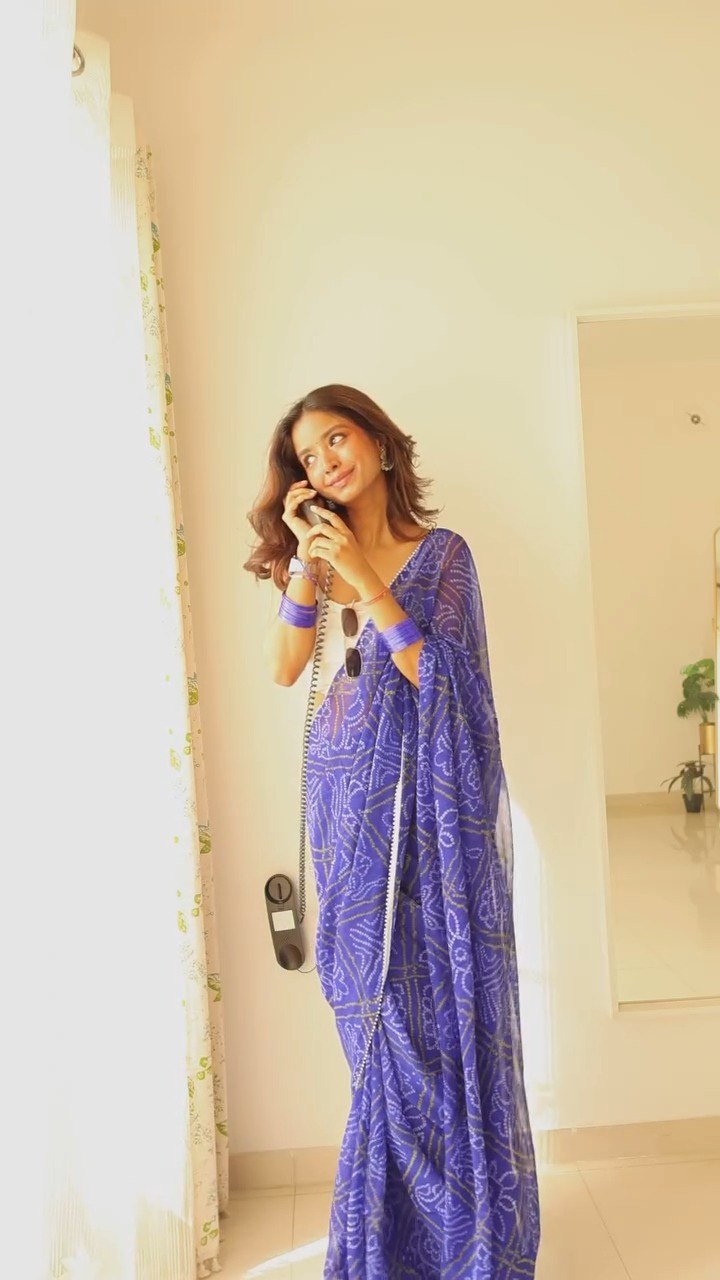 Model in flowing blue georgette saree, enjoying the light and airy fabric.