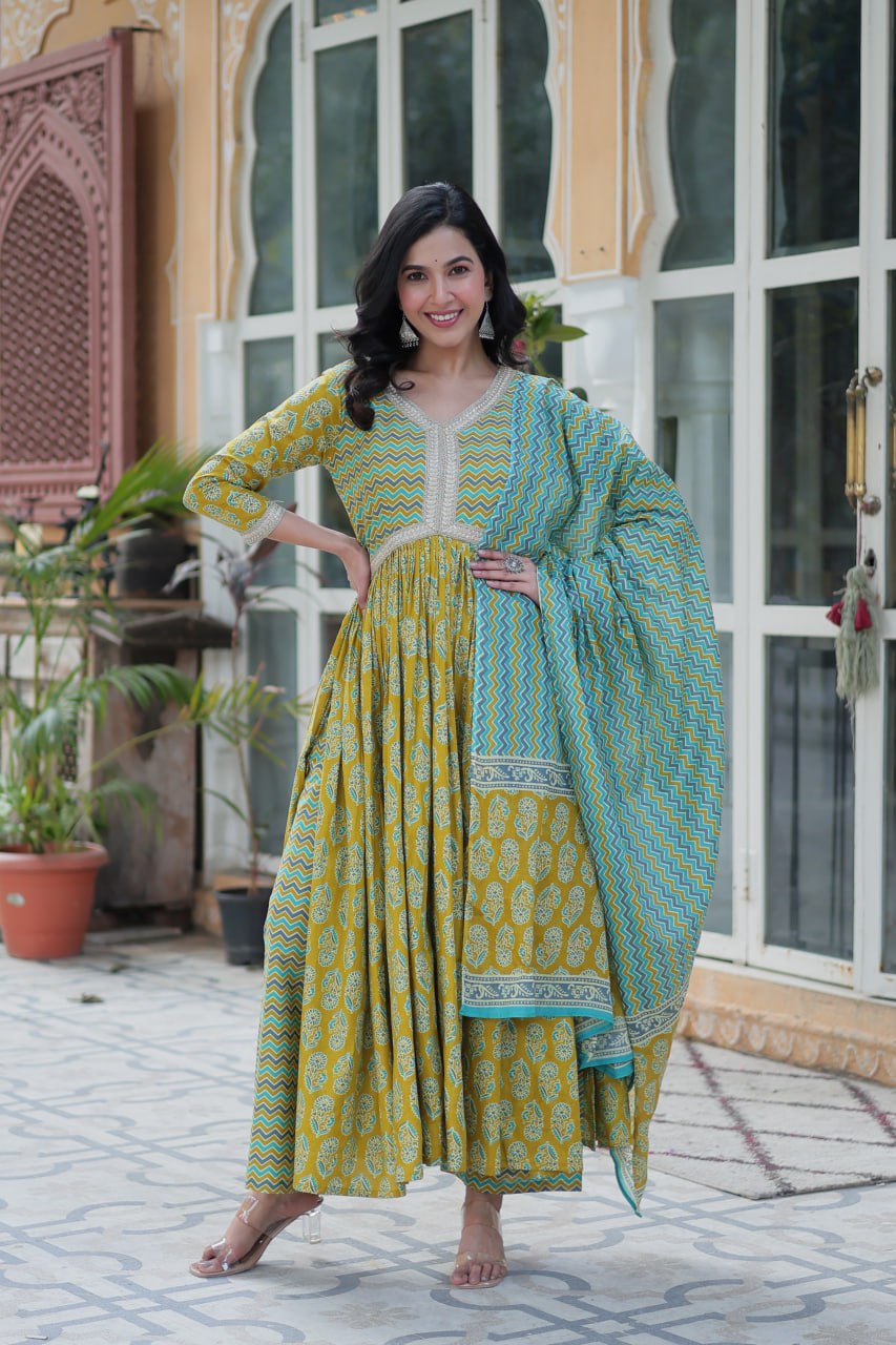Mustard and teal kurti set with chevron dupatta, block print, V-neck, full sleeves, model posing outdoors.