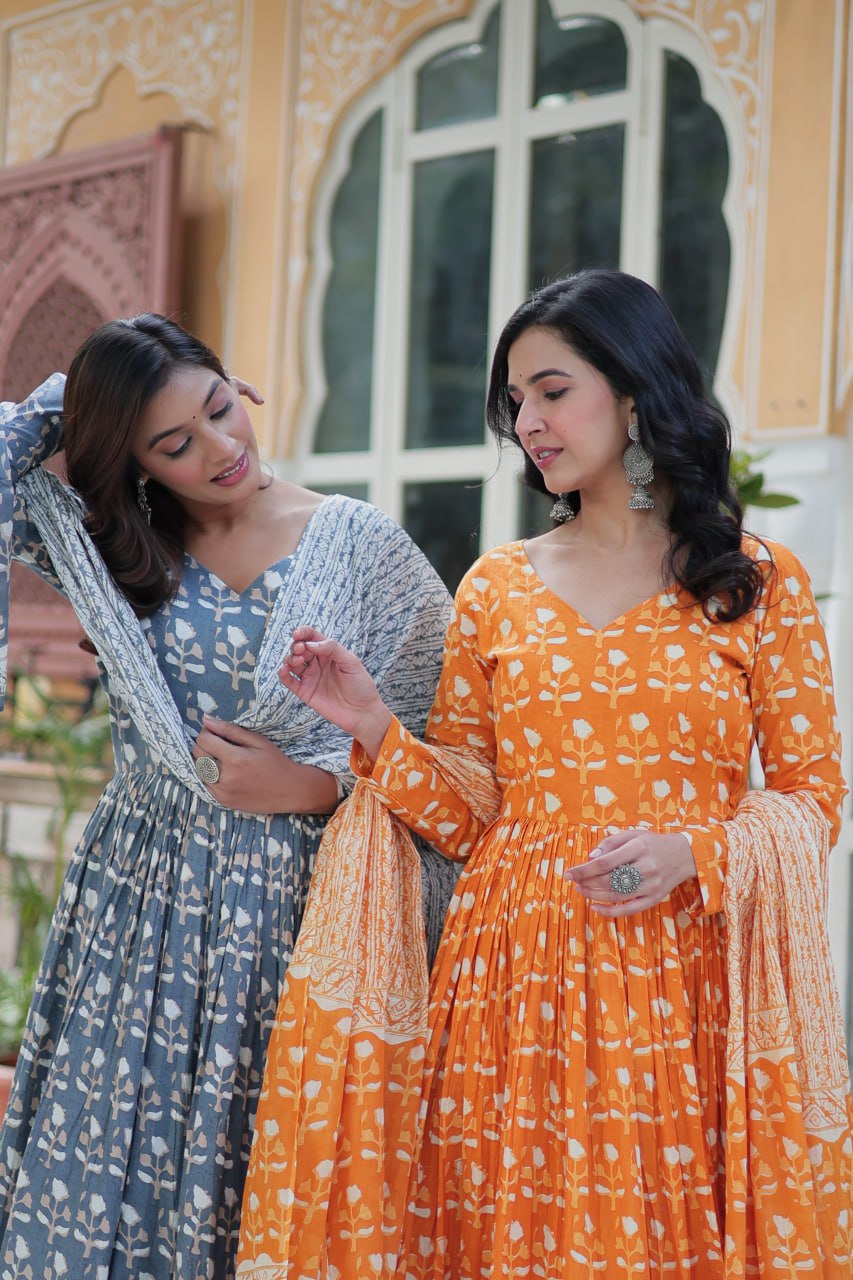 Close-up of two women in floral printed kurti sets, showcasing V-neck designs and breathable cotton fabric.