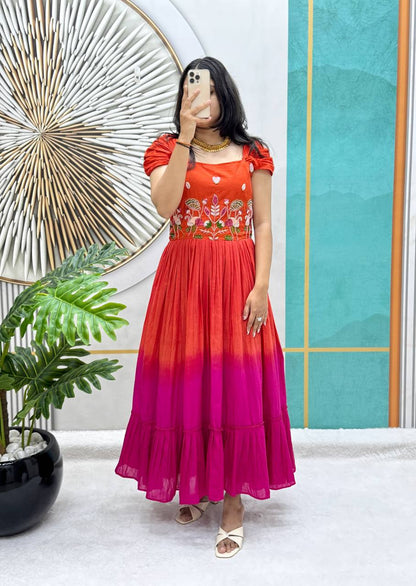 Full view of a orange and pink Festive Elegance Handworked Cotton Gown on a model.
