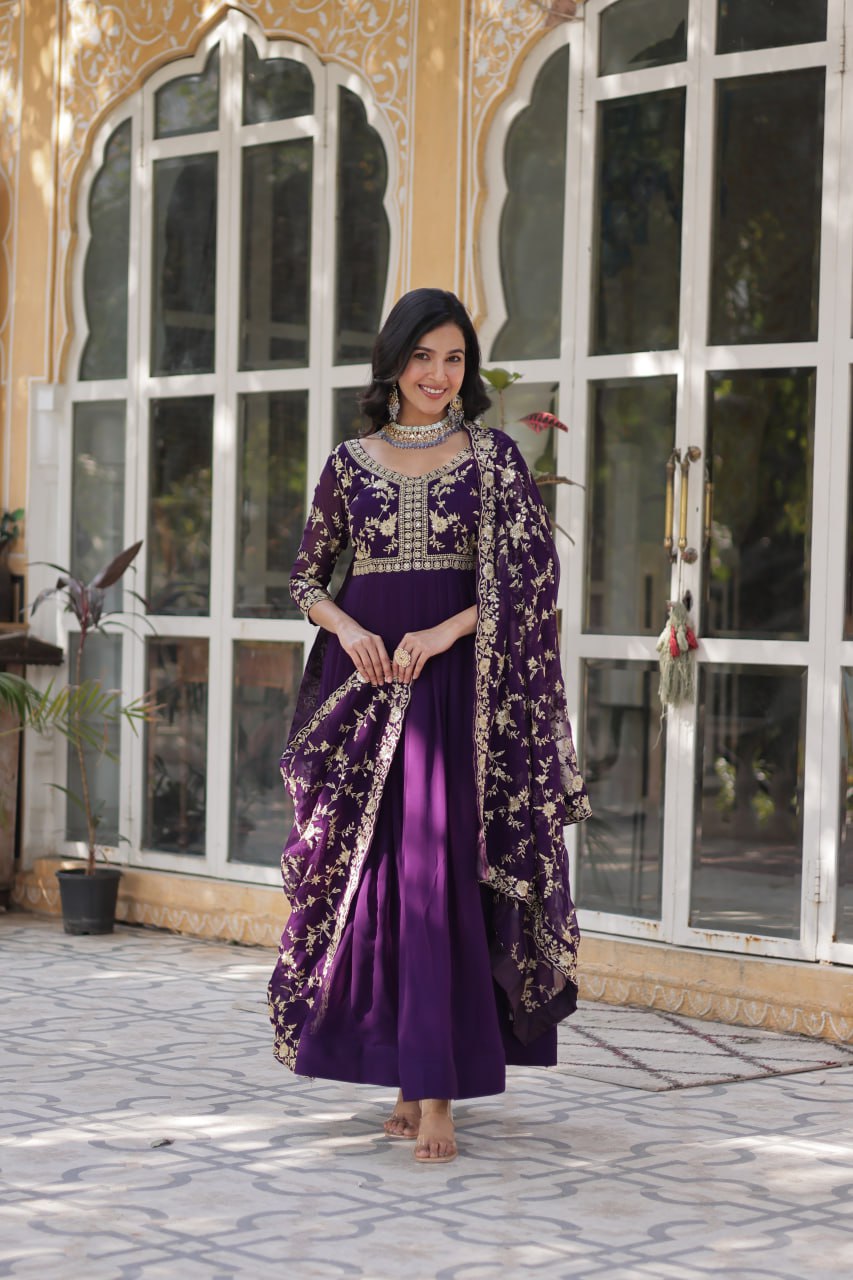 Premium purple gown featuring intricate gold embroidery and flowing dupatta.