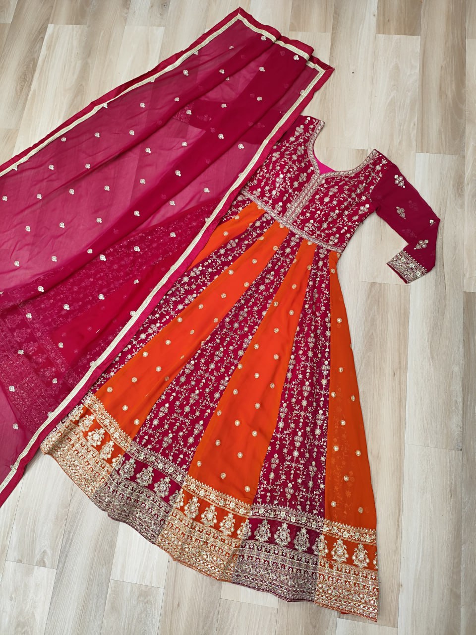Woman in a stunning blue and gold zari embroidered gown with dupatta.
