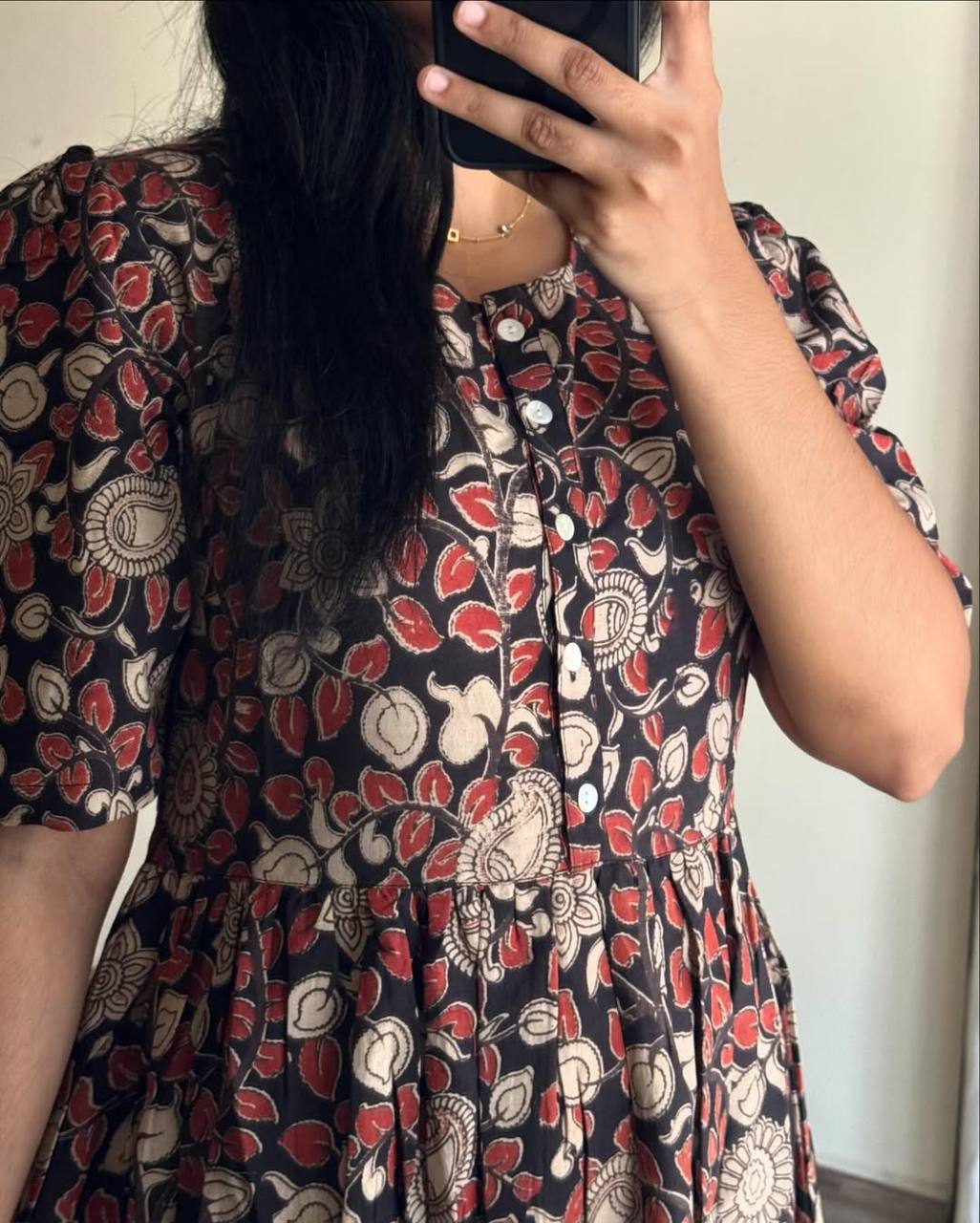 Close-up of the Kalamkari pattern and button detail on the Kalamkari dress.