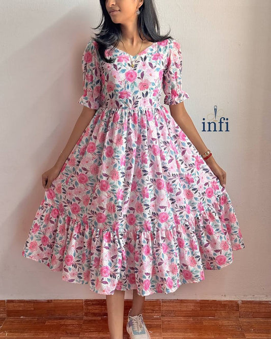Floral Lily Dress: A beautiful maxi dress with a delicate pink floral pattern and short sleeves.