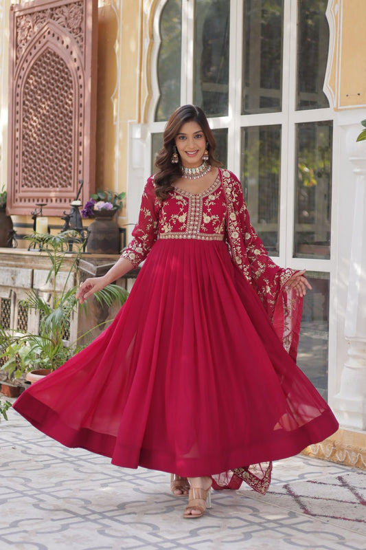 Premium pink gown featuring intricate gold embroidery and flowing dupatta.