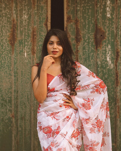 Woman poses in a stylish off-white and red floral georgette saree, ready-to-wear.