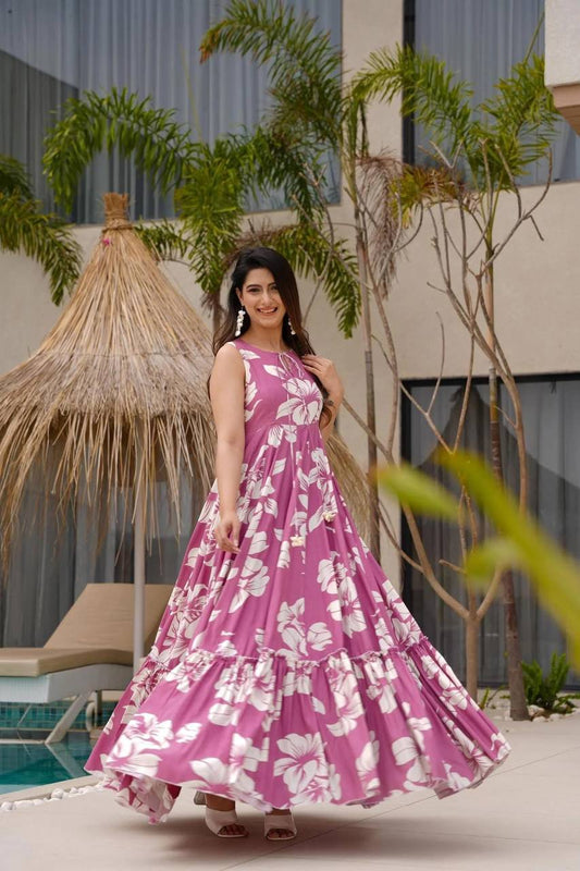 Woman in pink blossom cotton dress, South Indian style, smiling and twirling.