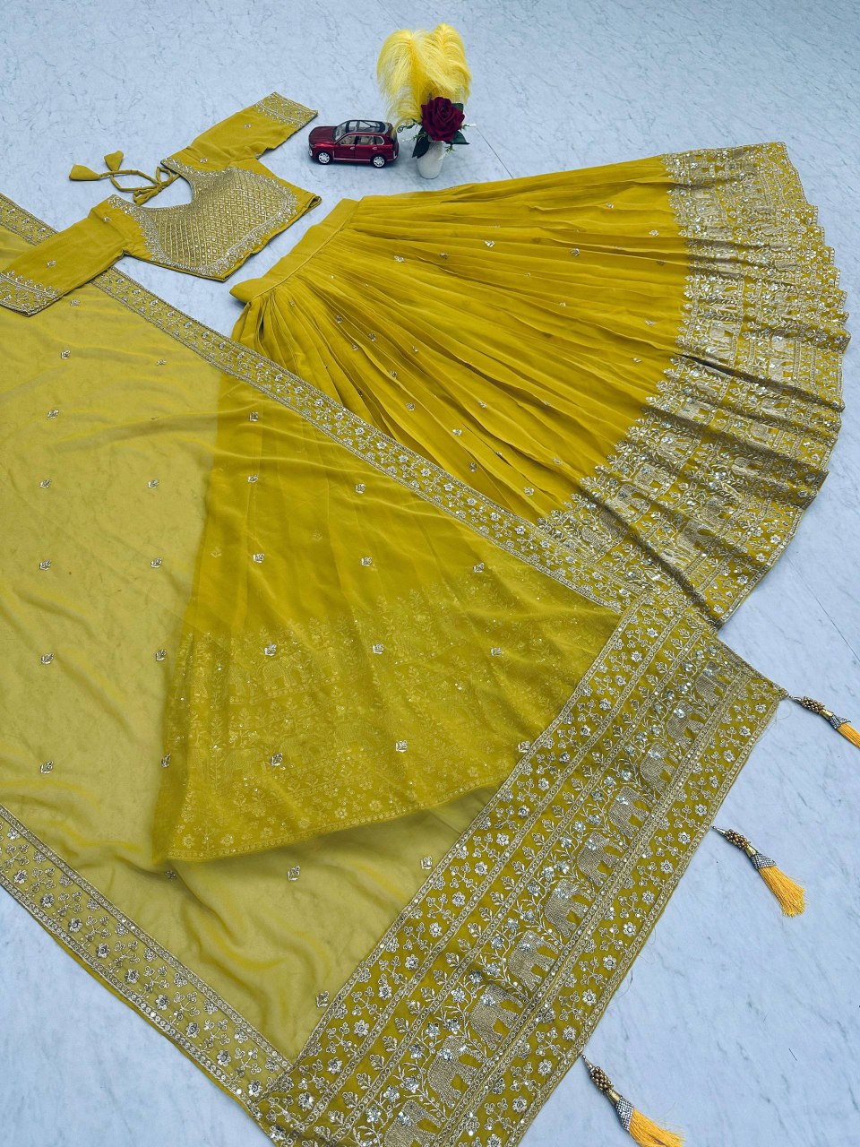 Lime green lehenga choli set with dupatta, showcasing the embroidery and tassels.