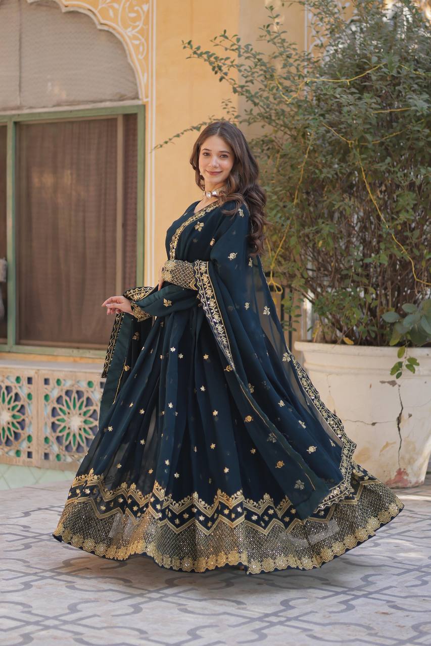 Model showcasing a teal embroidered Anarkali gown with a 3.5-meter flare.