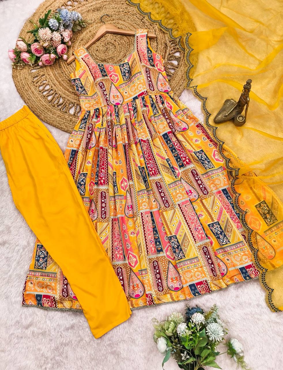 Elegant yellow Anarkali suit set with vibrant prints and sheer dupatta.