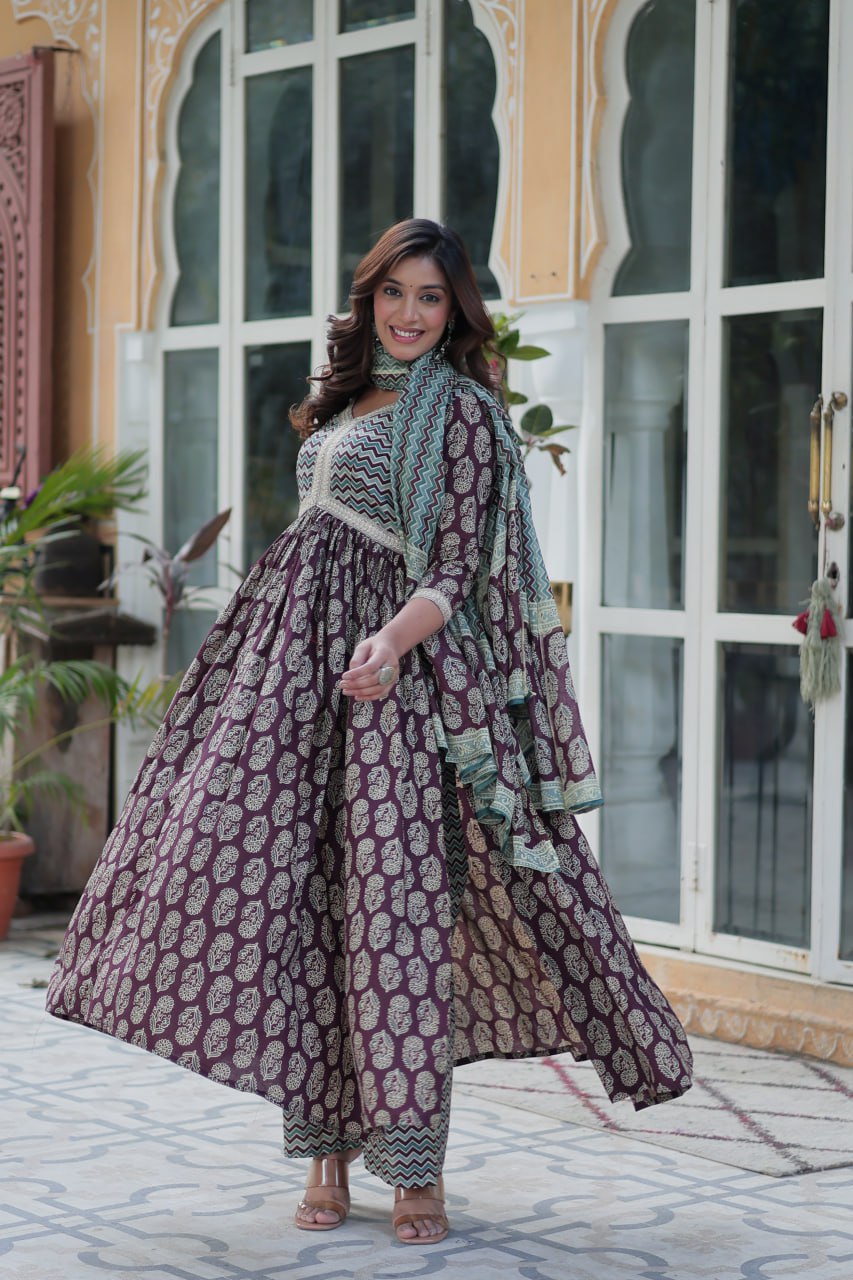 Maroon and gold block print cotton kurti set with teal chevron dupatta, graceful Anarkali fit, outdoors.