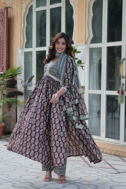 Maroon and gold block print cotton kurti set with teal chevron dupatta, graceful Anarkali fit, outdoors.