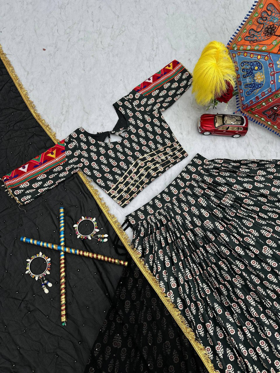 Top view of Gamathi Glam lehenga choli set with embroidered dupatta and Navratri accessories.