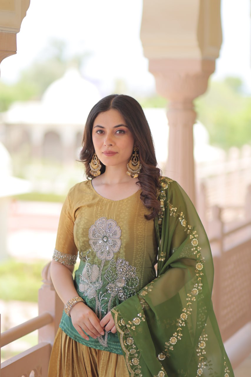 Model wearing olive green Sharara Suit with Dupatta and jewelry