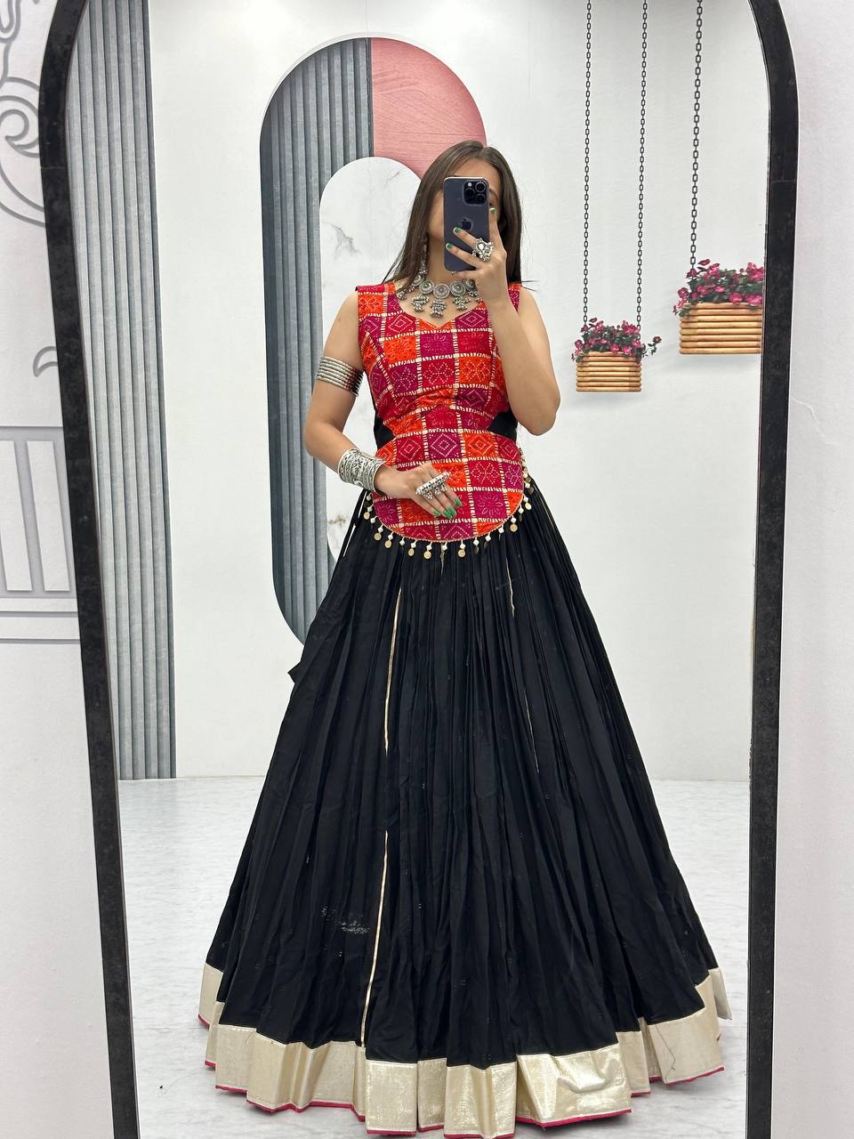 Mirror selfie of model in black cotton lehenga choli set with gold trim, ready-to-wear for Navratri.
