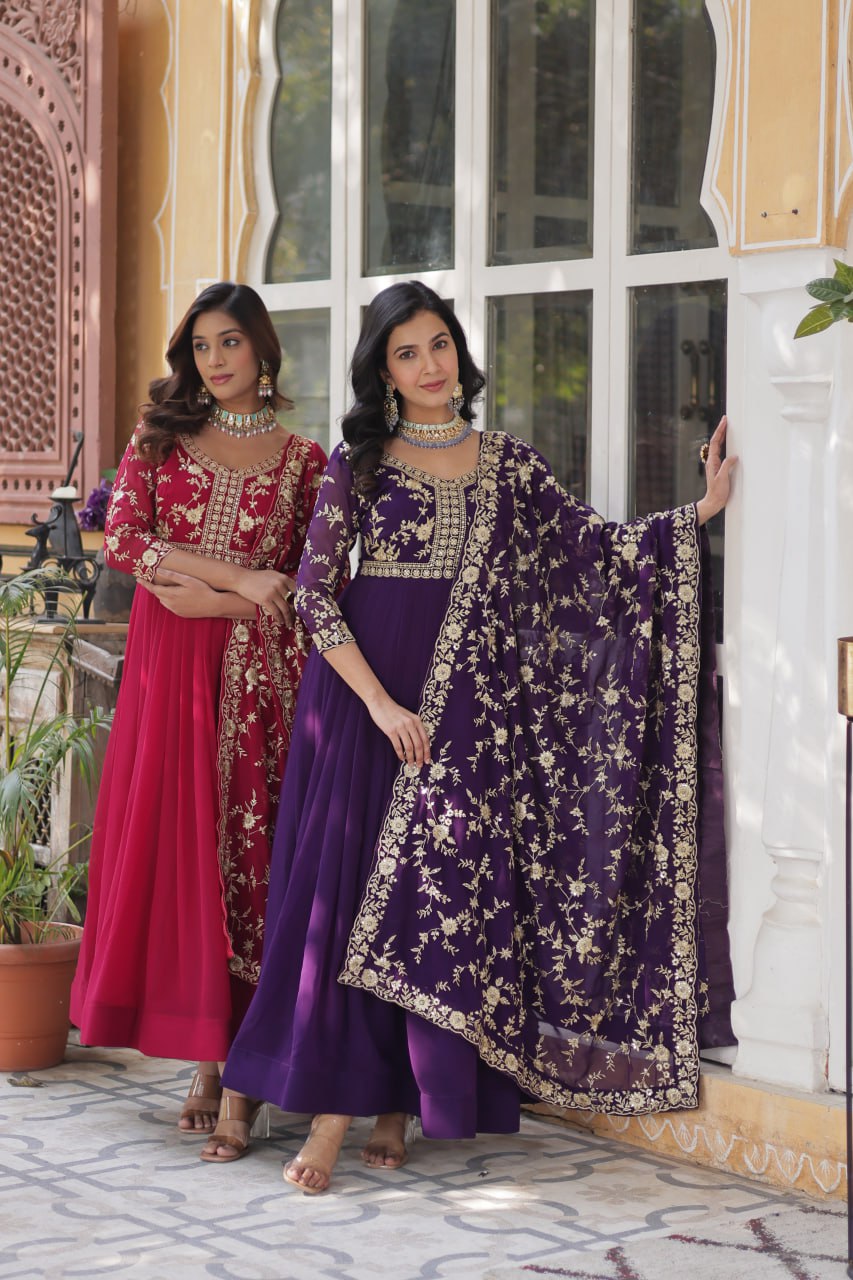 Two models in premium pink and purple zari embroidered Indian gowns.