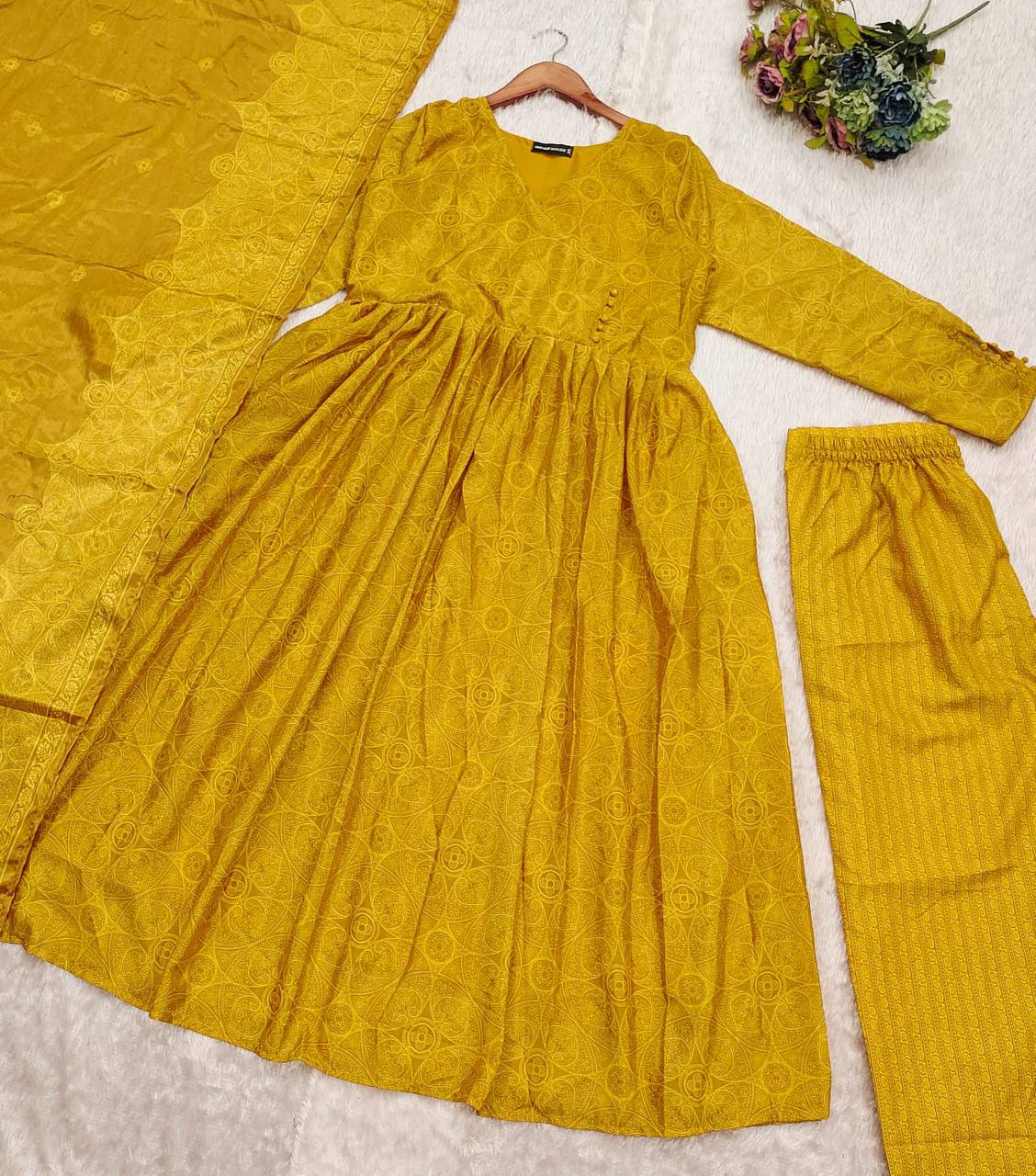 Flat lay of Golden Bandhani Anarkali Suit Set with dupatta and bottoms. Ethnic dress.