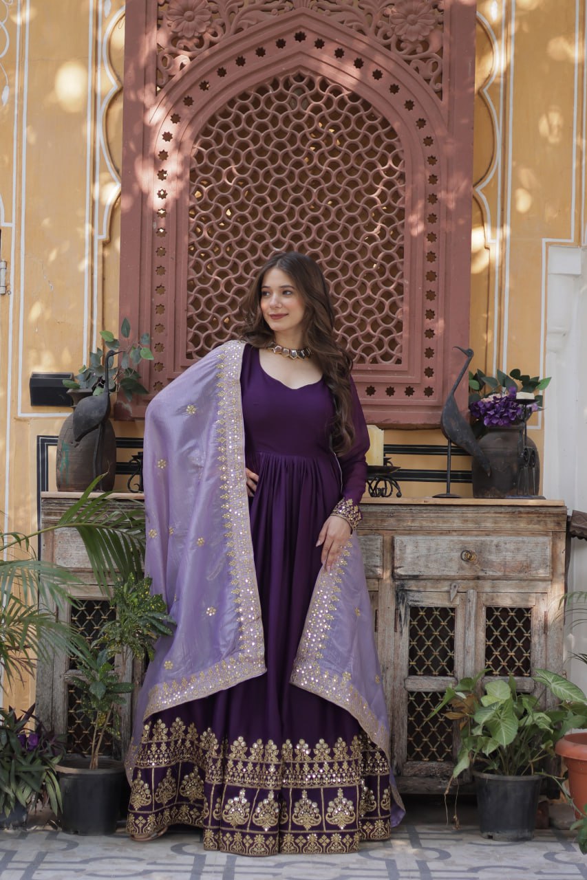 Woman wearing purple embroidered gown with matching dupatta.