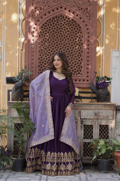 Woman wearing purple embroidered gown with matching dupatta.