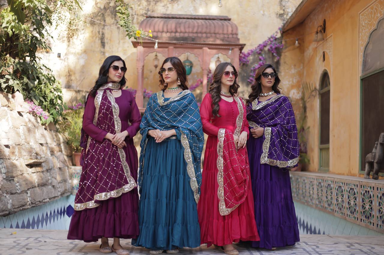 Women wearing purple, teal, and red flared gowns with sequin embroidered dupattas.