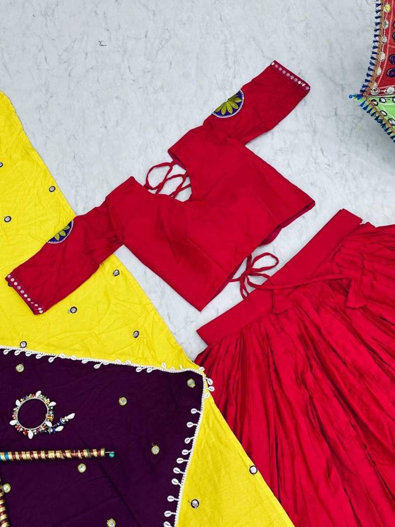 Flat lay of pink lehenga, matching choli, and half-yellow, half-purple embroidered dupatta on marble surface.