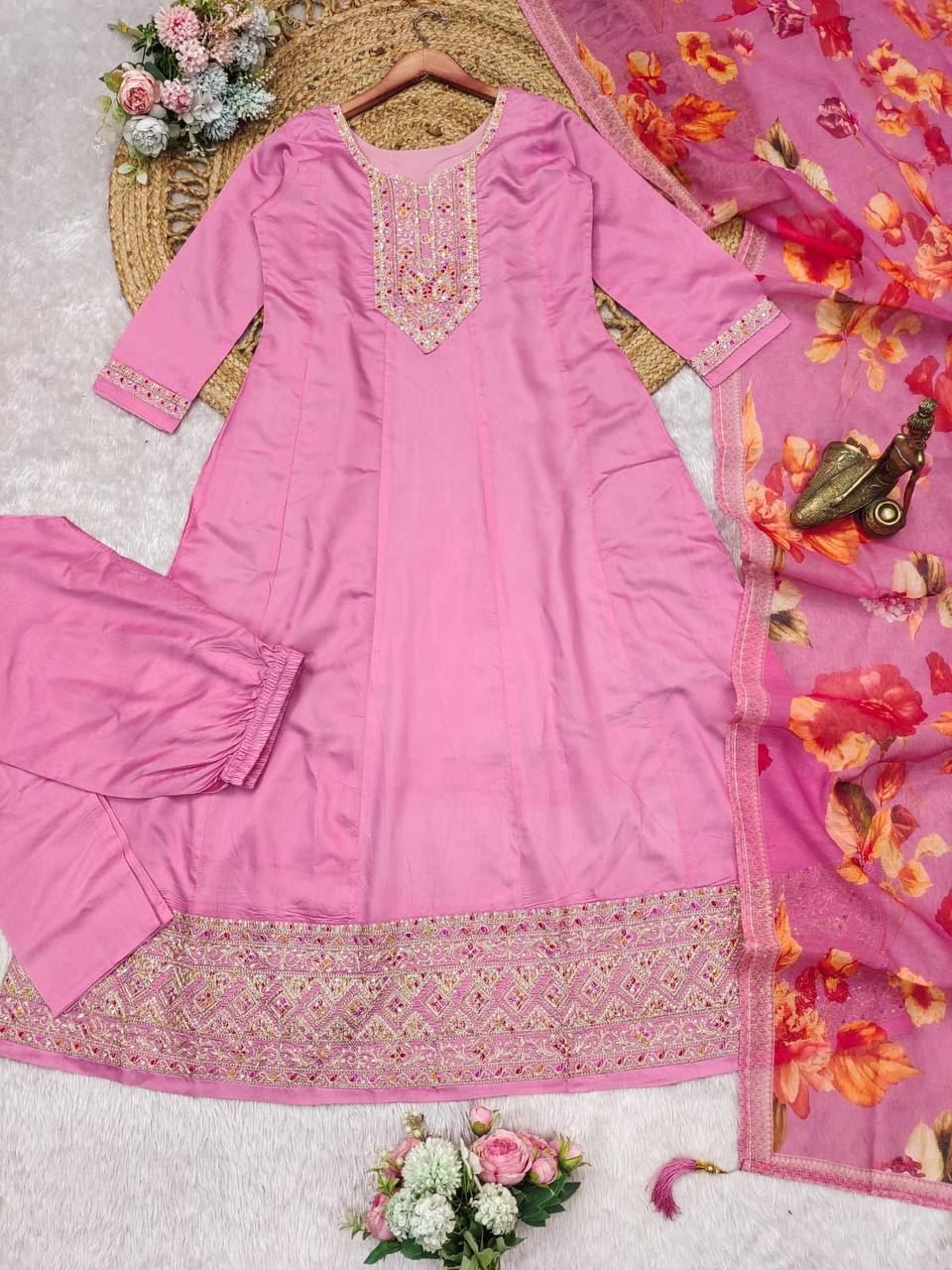 Close up of the embroidered neckline on the pastel pink Anarkali kurta.