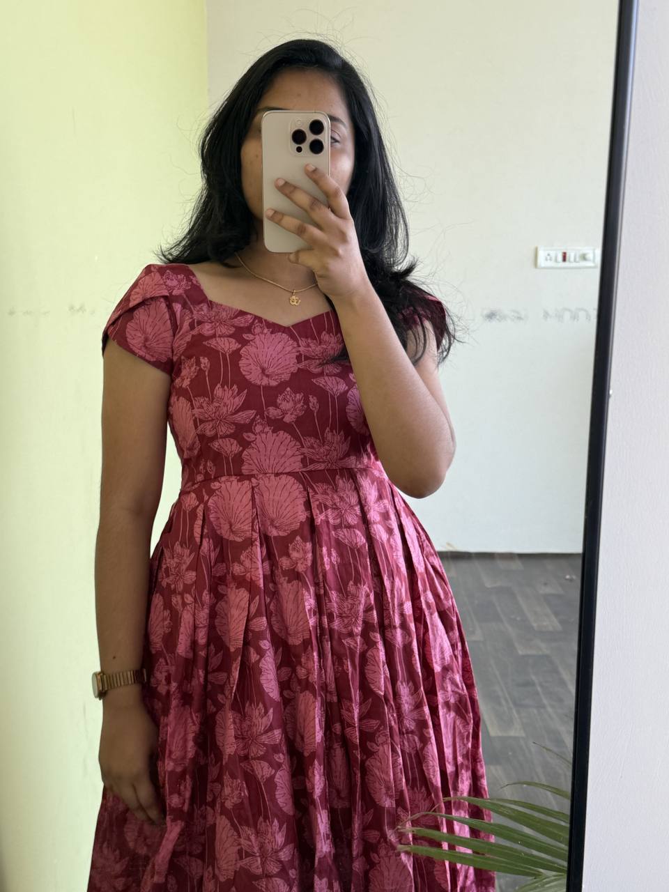Maroon Lotus dress on model. A-line floral dress with short sleeves and a flattering silhouette.