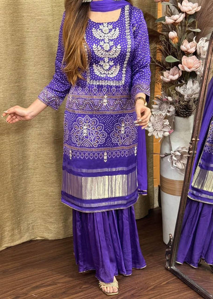 Elegant purple kurta pajama set featuring Bandhani print and silver accents.