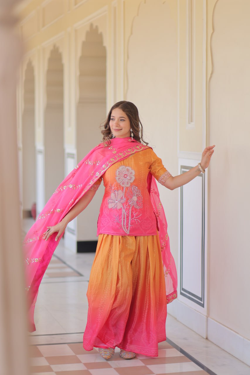 Model posing in Sharara Suit with open pink dupatta